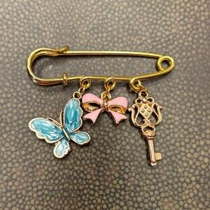 Gold Brooch with Blue Butterfly, Pink Bow, and Key Charms